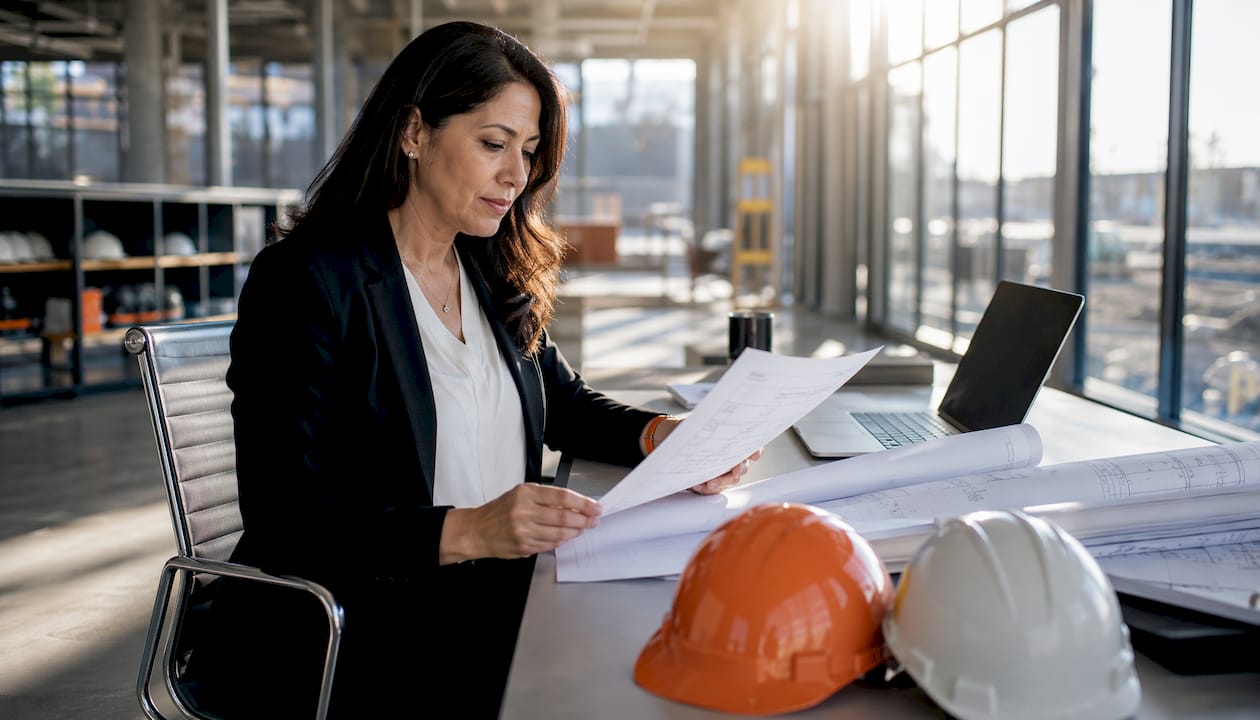 Project manager reviewing onboarding checklist onsite