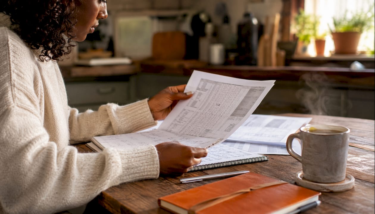 Hands calculating contractor bid profit margins