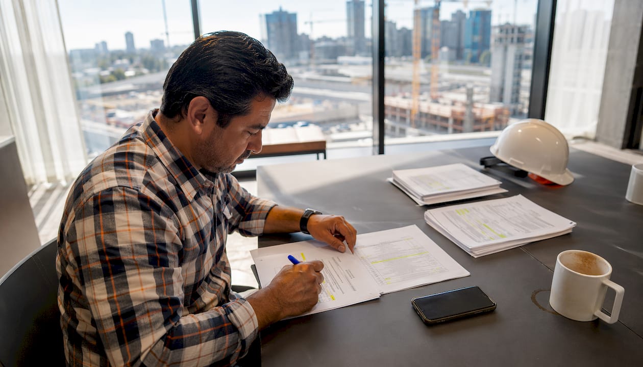 Contractor reviewing bid screening checklist