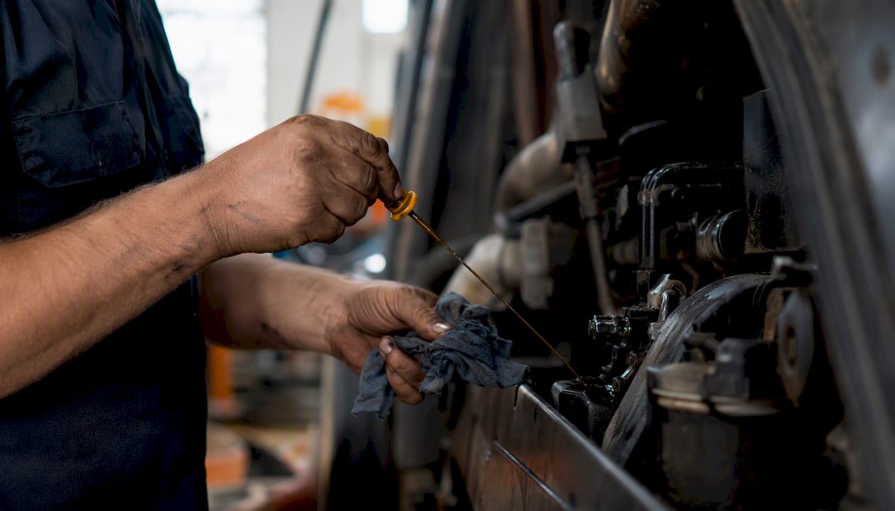 Hands checking vibration on construction equipment motor
