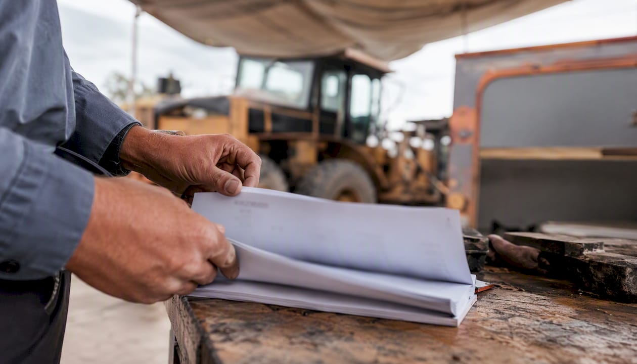 Hands checking maintenance tools and logbook