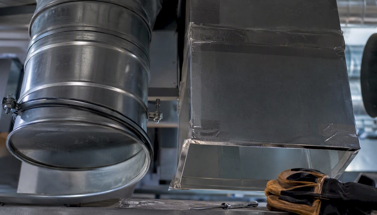 Round and rectangular metal duct sections side by side