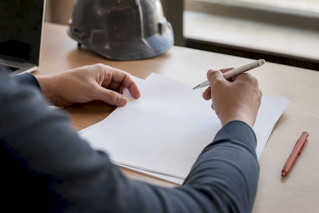 Hands reviewing staffing contract document
