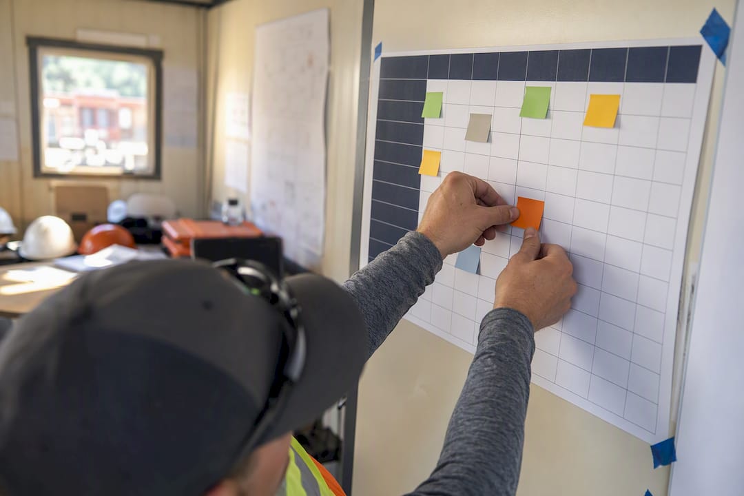 Hands assigning roles on RACI chart
