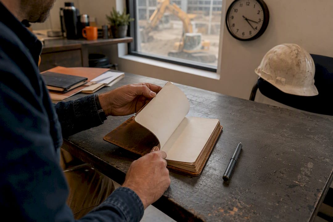 Hands turning blank notebook during pipeline review