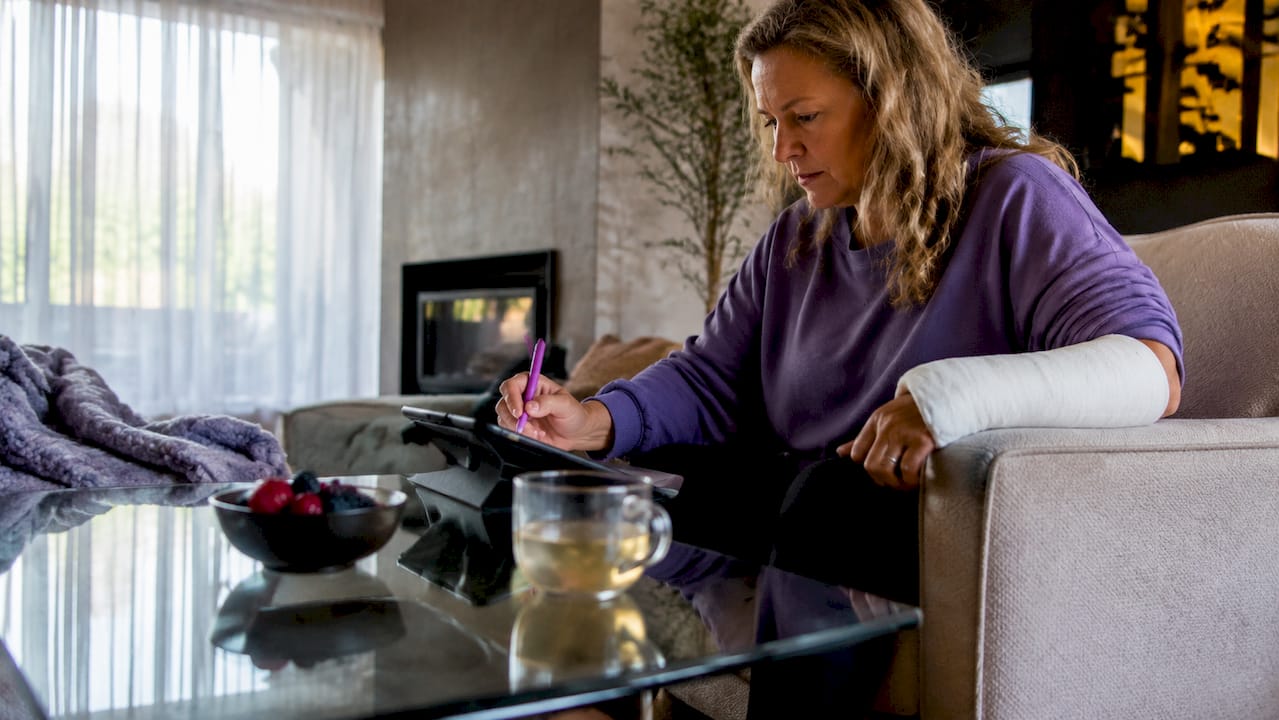 Woman planning daily post-fracture care schedule