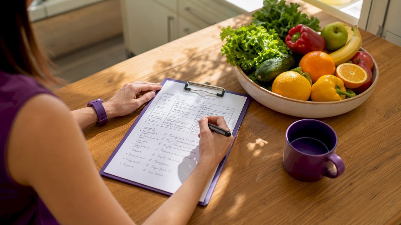 Hands of nutritionist taking bone healing notes
