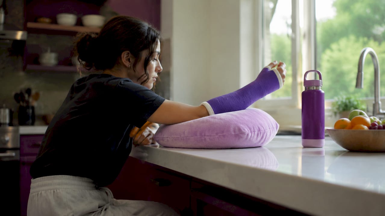 Elevated casted arm on pillow indoors