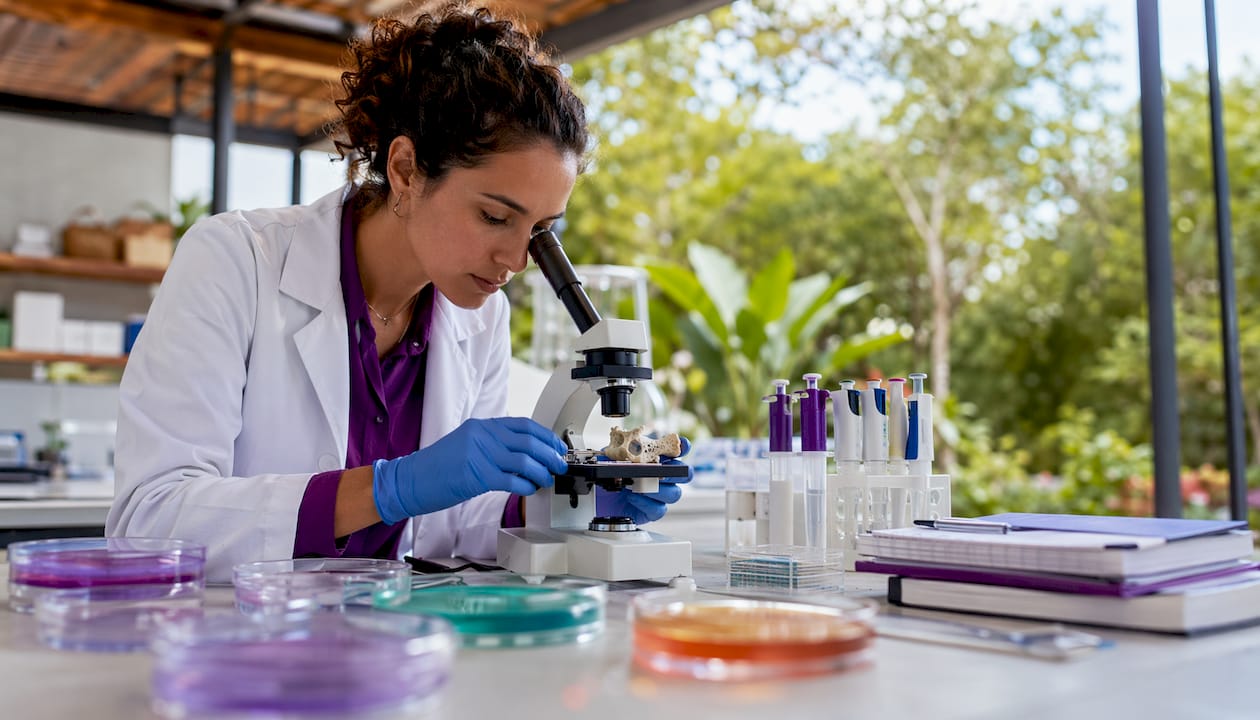Researcher studying collagen samples in lab