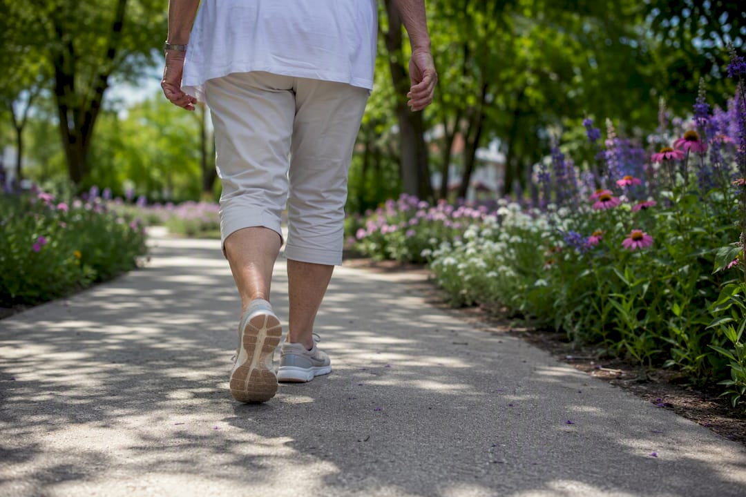 Older adult walking outdoors for bone health