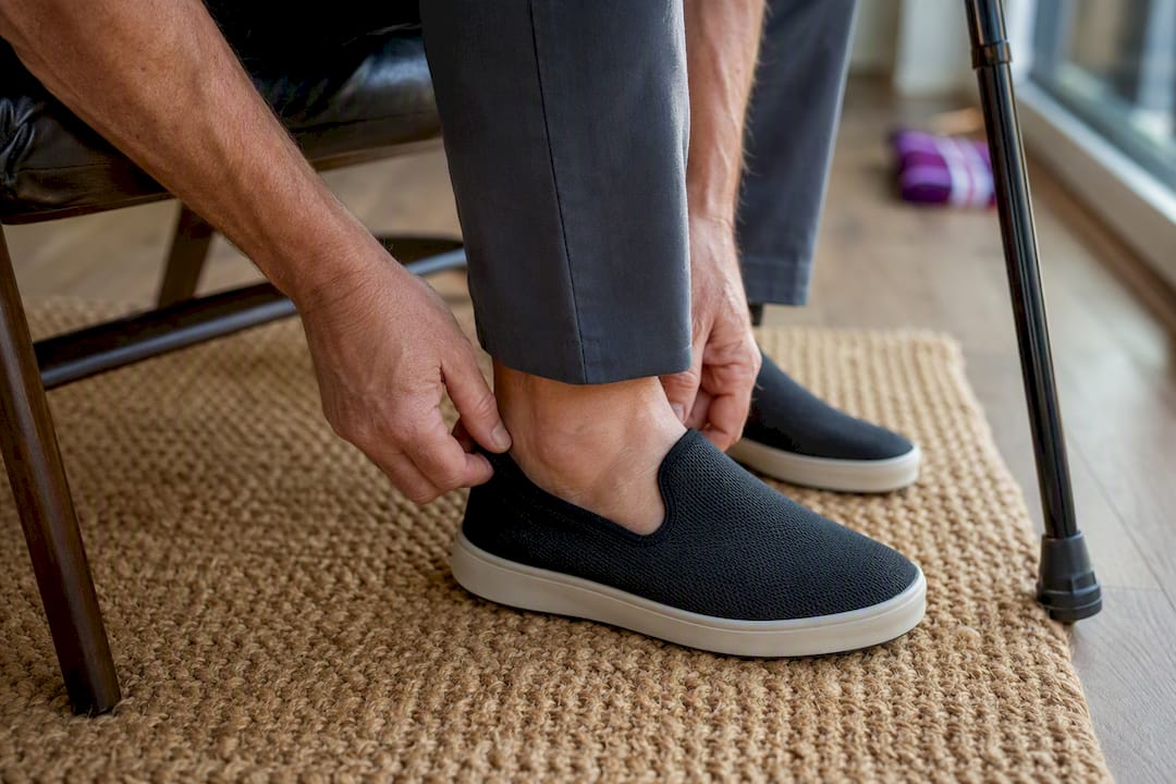 Seated person checking shoe and trouser fit