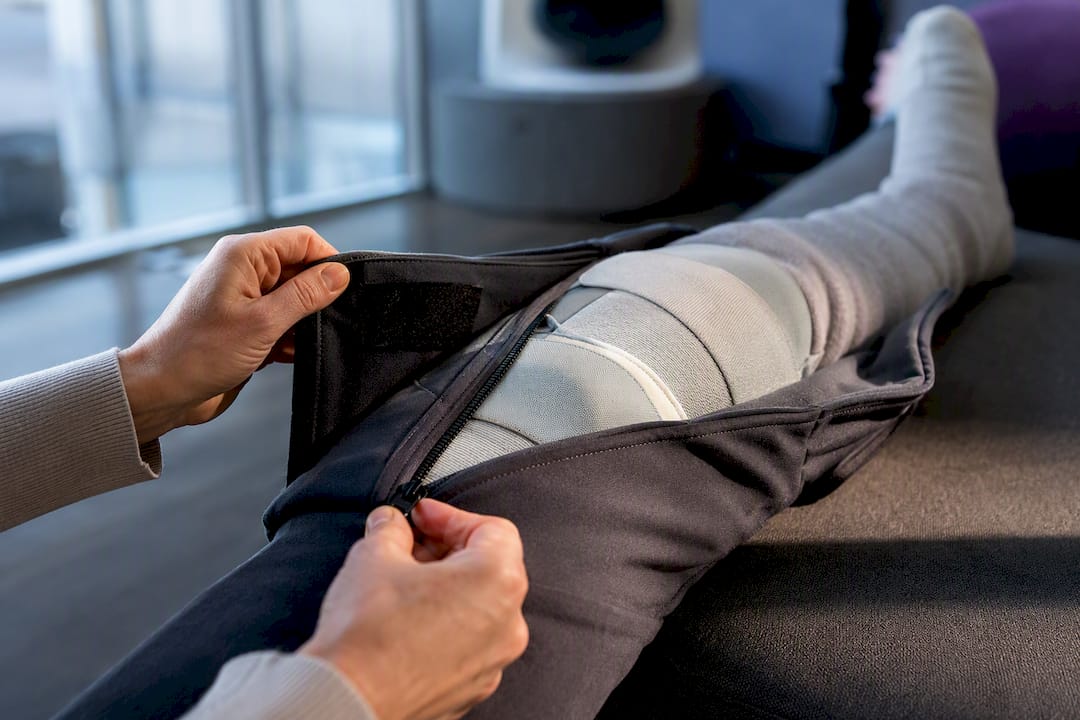 Caregiver adjusting clothing around a leg brace