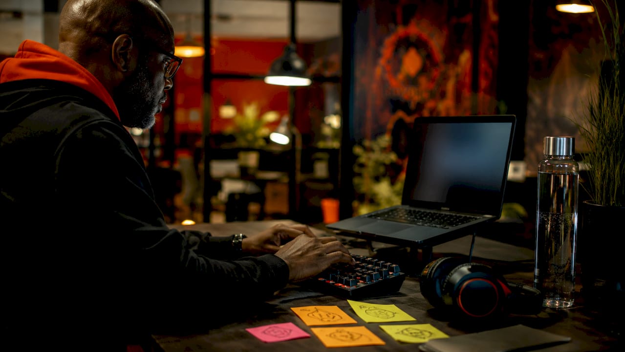 Hands typing on keyboard in tech novel adaptation workspace