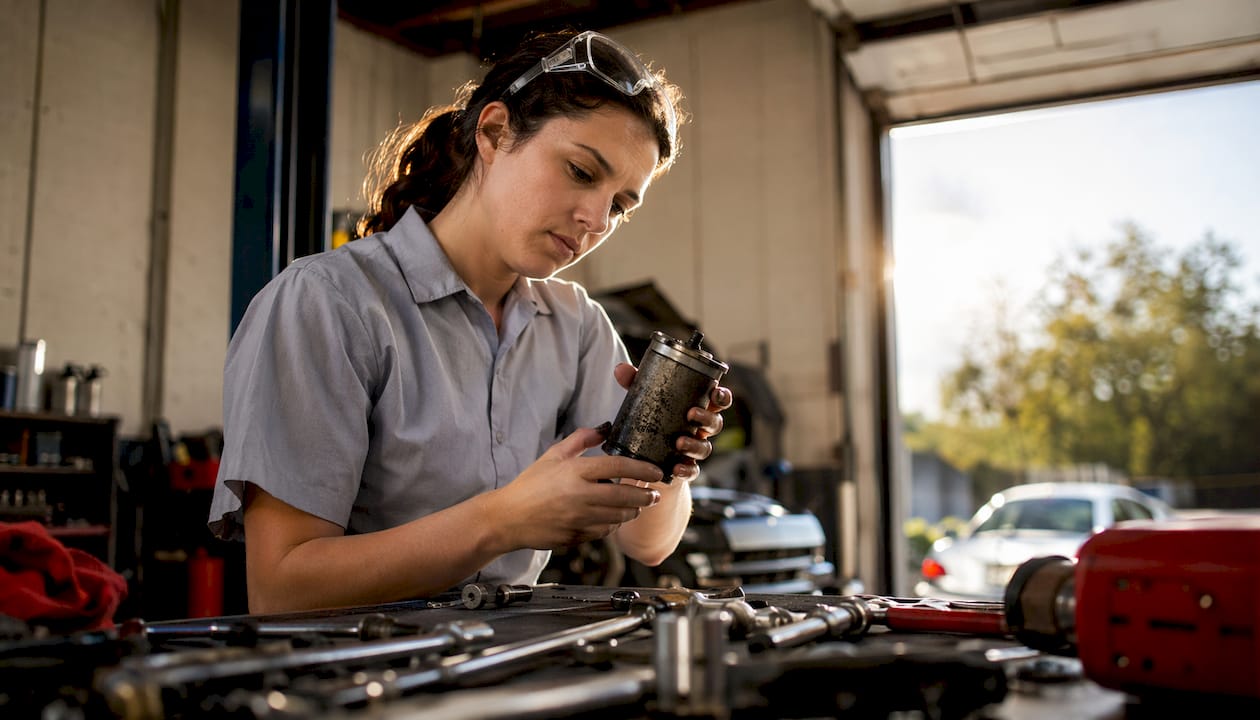Technician inspecting a clogged fuel filter