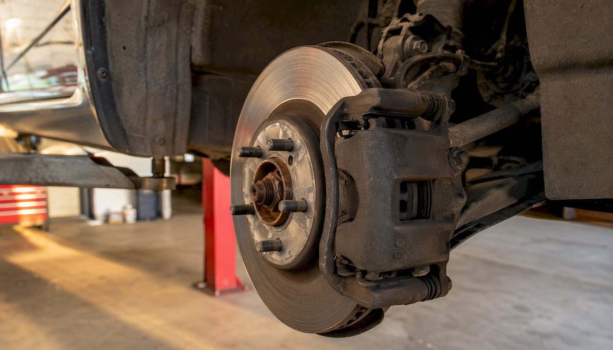 Close-up of disc brake caliper and rotor outdoors