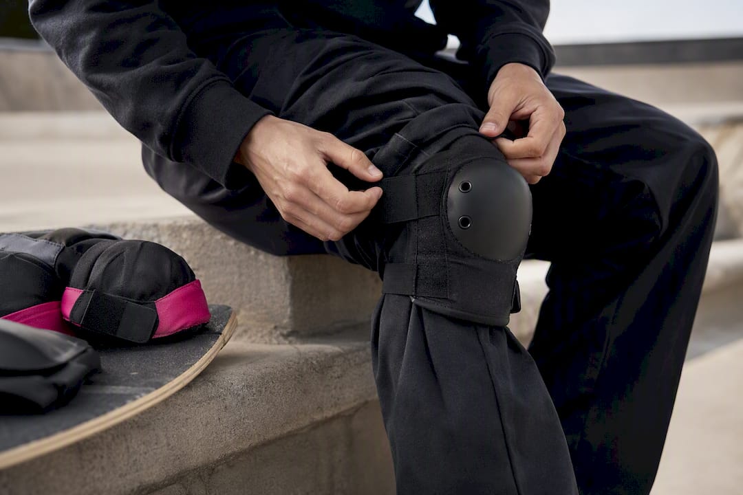 Knee pad fitted beneath skate pants