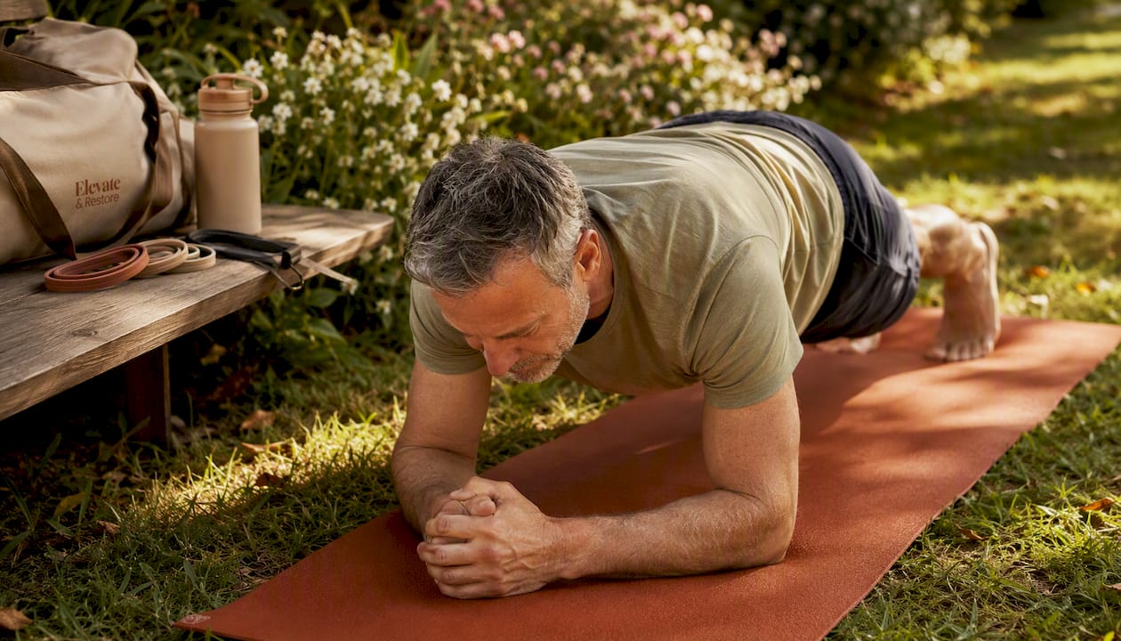 Man holding plank exercise in gym