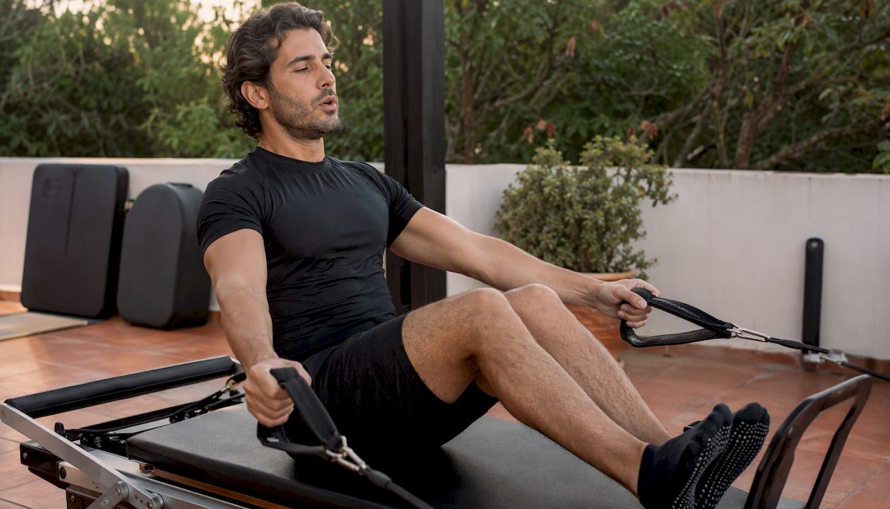 Man exhaling during Pilates exercise