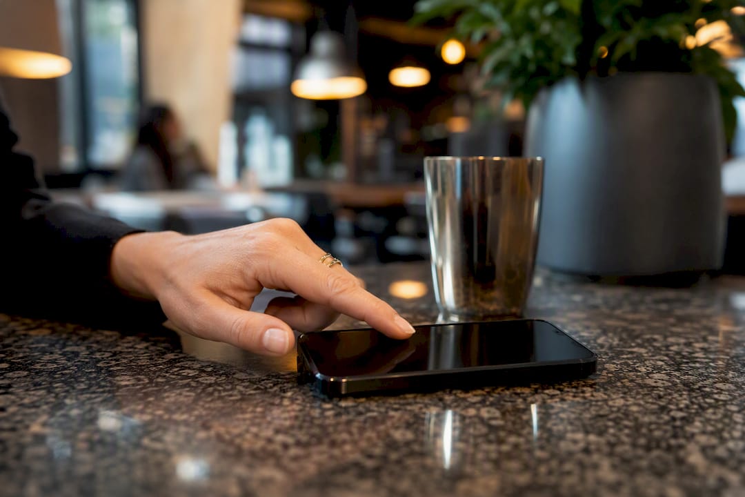 Hand navigating privacy settings on smartphone