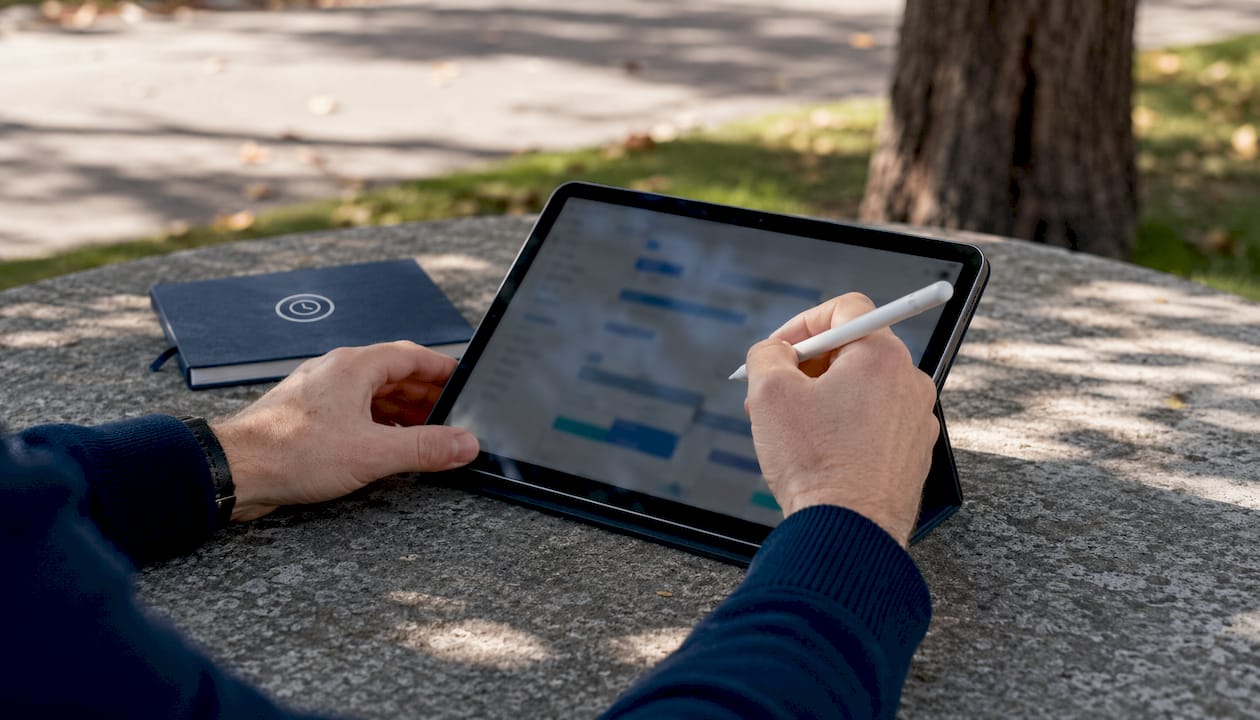 Hands using tablet for employee availability scheduling