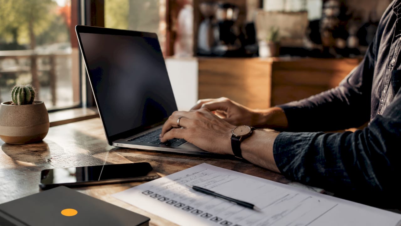 Hands typing with CRM and call notes nearby