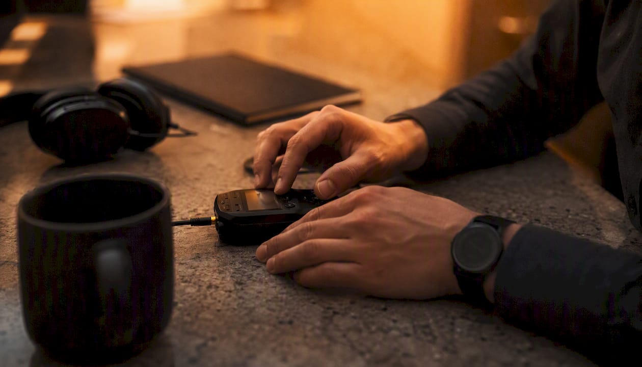 Hands transcribing sales call recordings