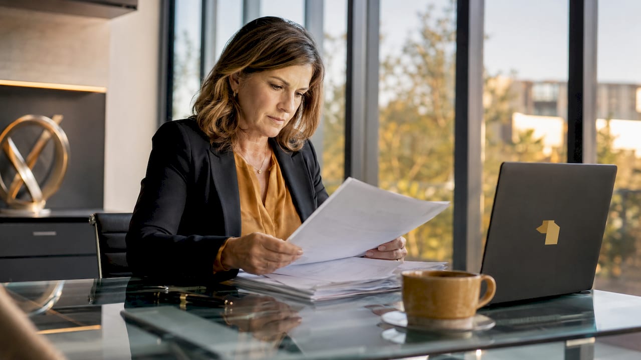 Property manager reviewing leasing documents at desk