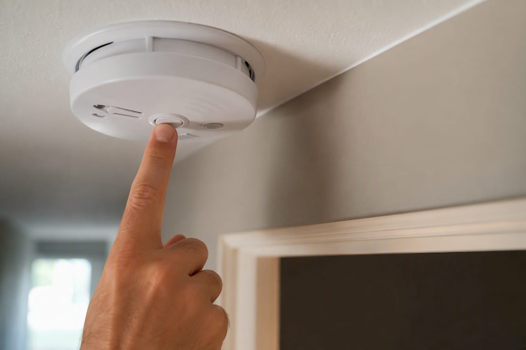 Tenant pressing smoke alarm test button