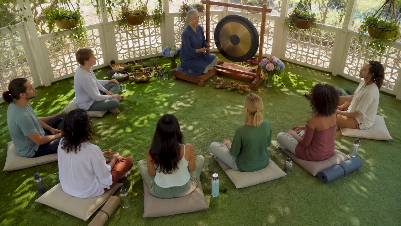Group sound bath session in community hall