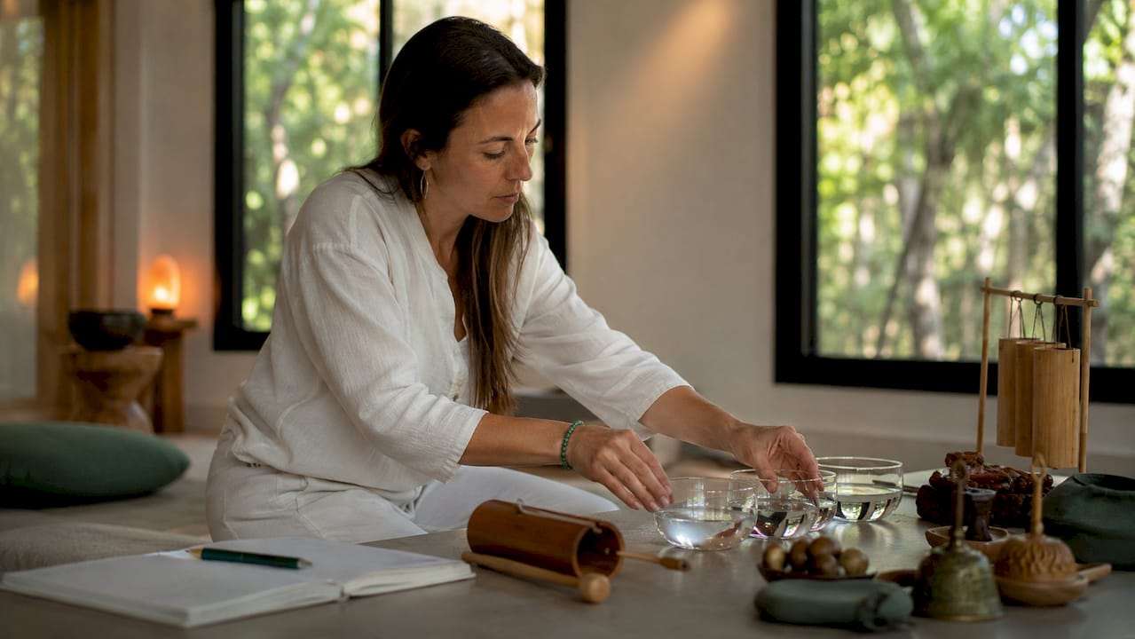 Sound therapist arranging healing sound instruments in studio