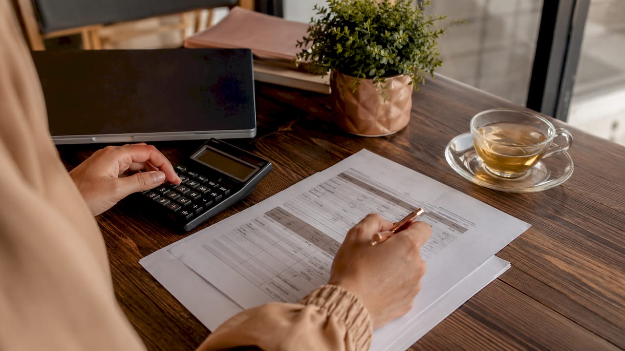 Hands calculating import fees for cosmetics