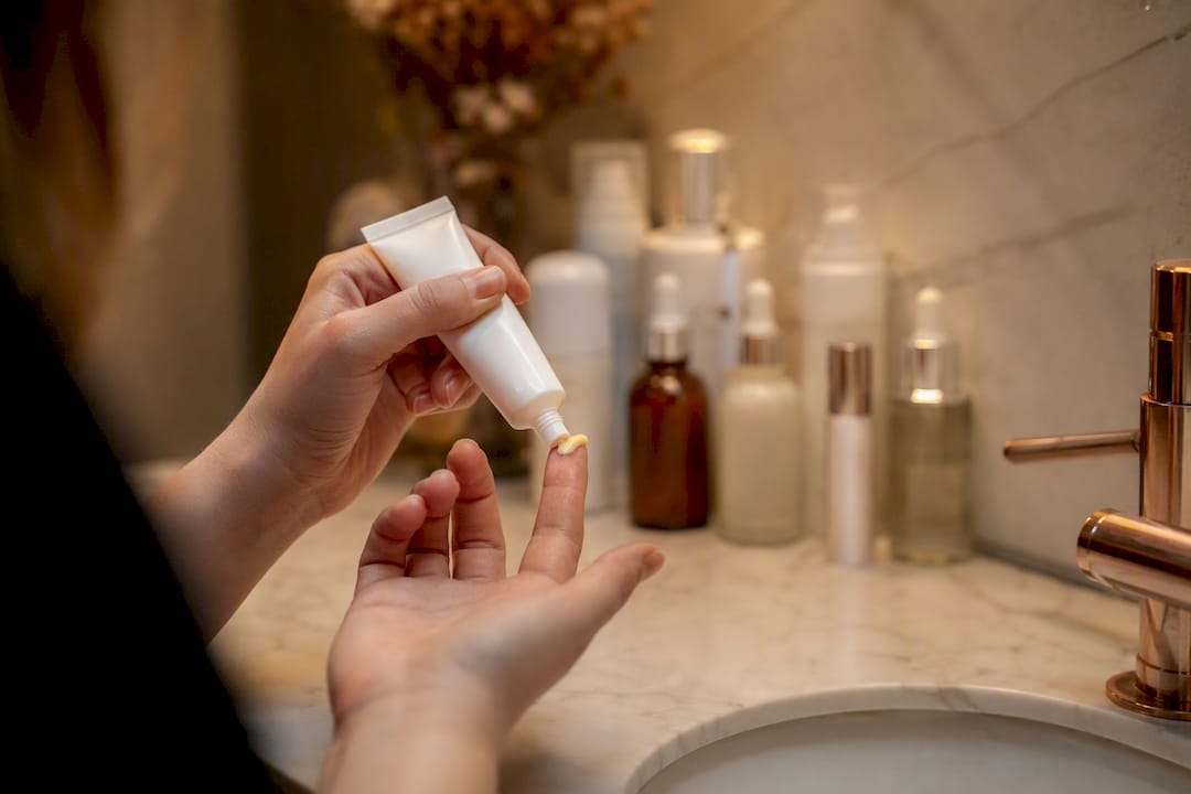 Hand with retinoid cream on fingertip