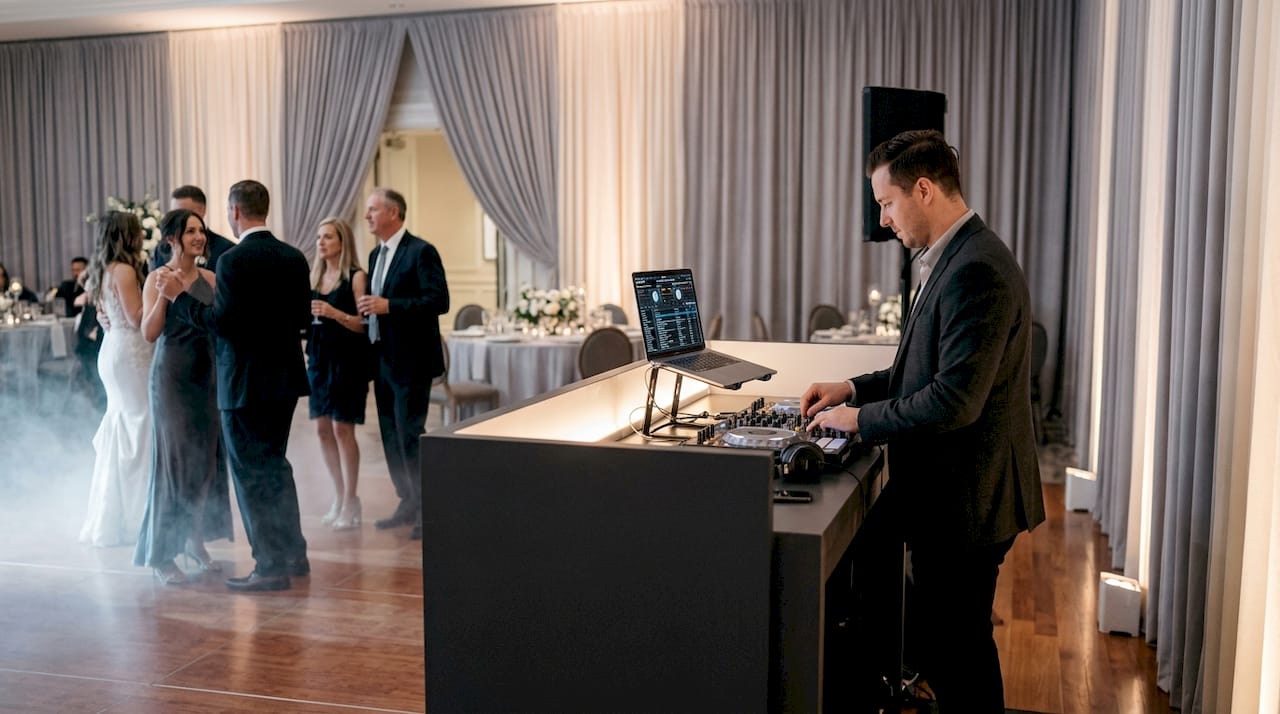 DJ booth with lighting and special effects at wedding