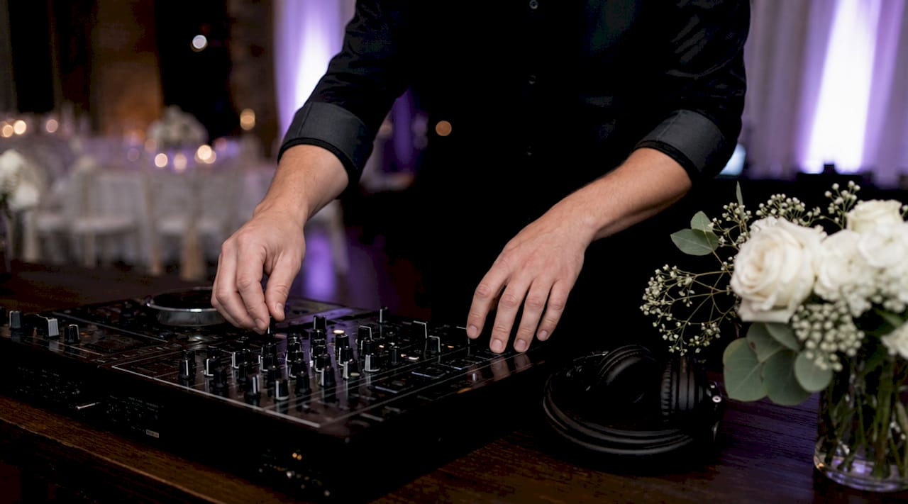 DJ adjusting tempo and key on mixer