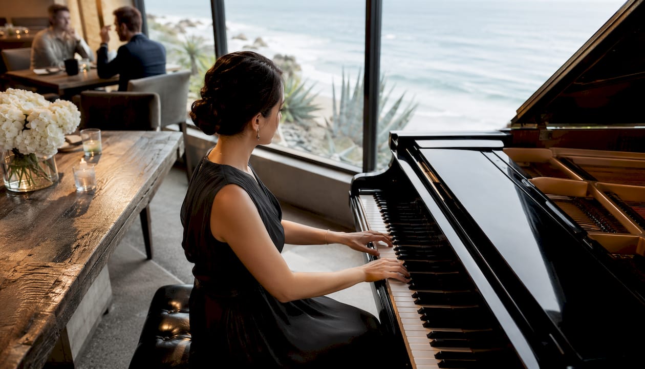 Female pianist playing grand piano at corporate event
