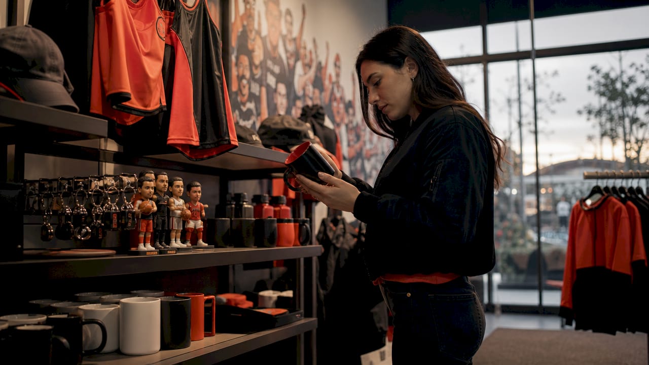 Shopper browsing fan merchandise display