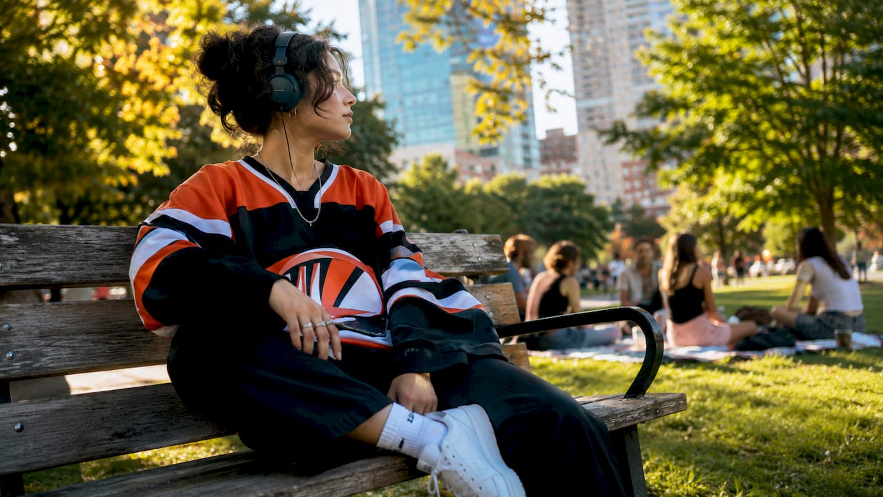 Young woman wearing vintage hockey jersey on street