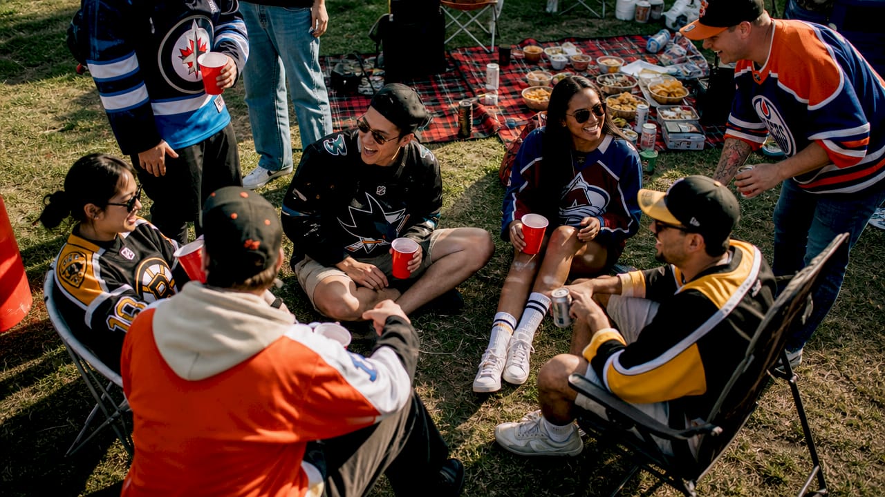 Group wearing varied hockey fan apparel outdoors