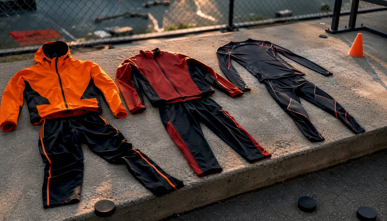 Three hockey warm-up clothing styles laid out