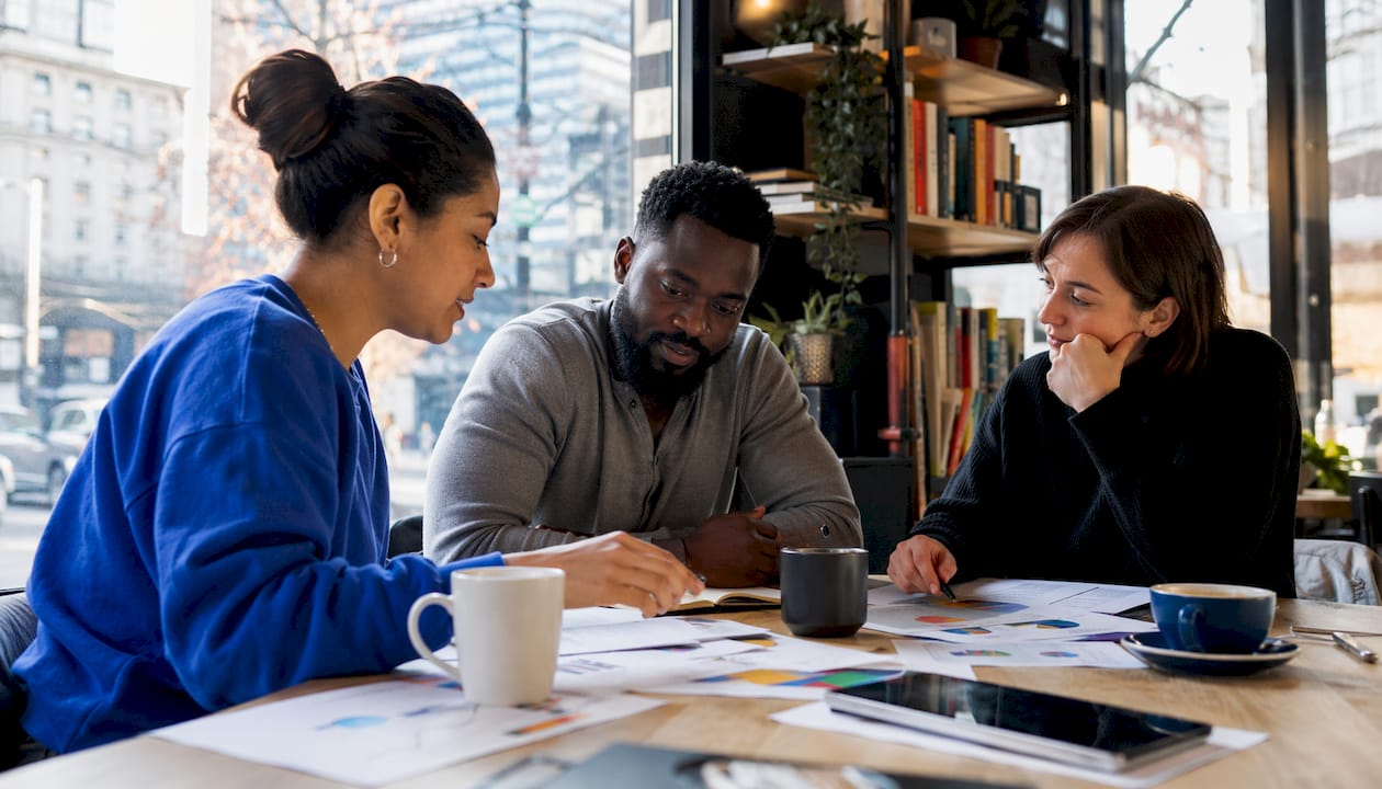 Small team discussing local SEO strategy in co-working space.
