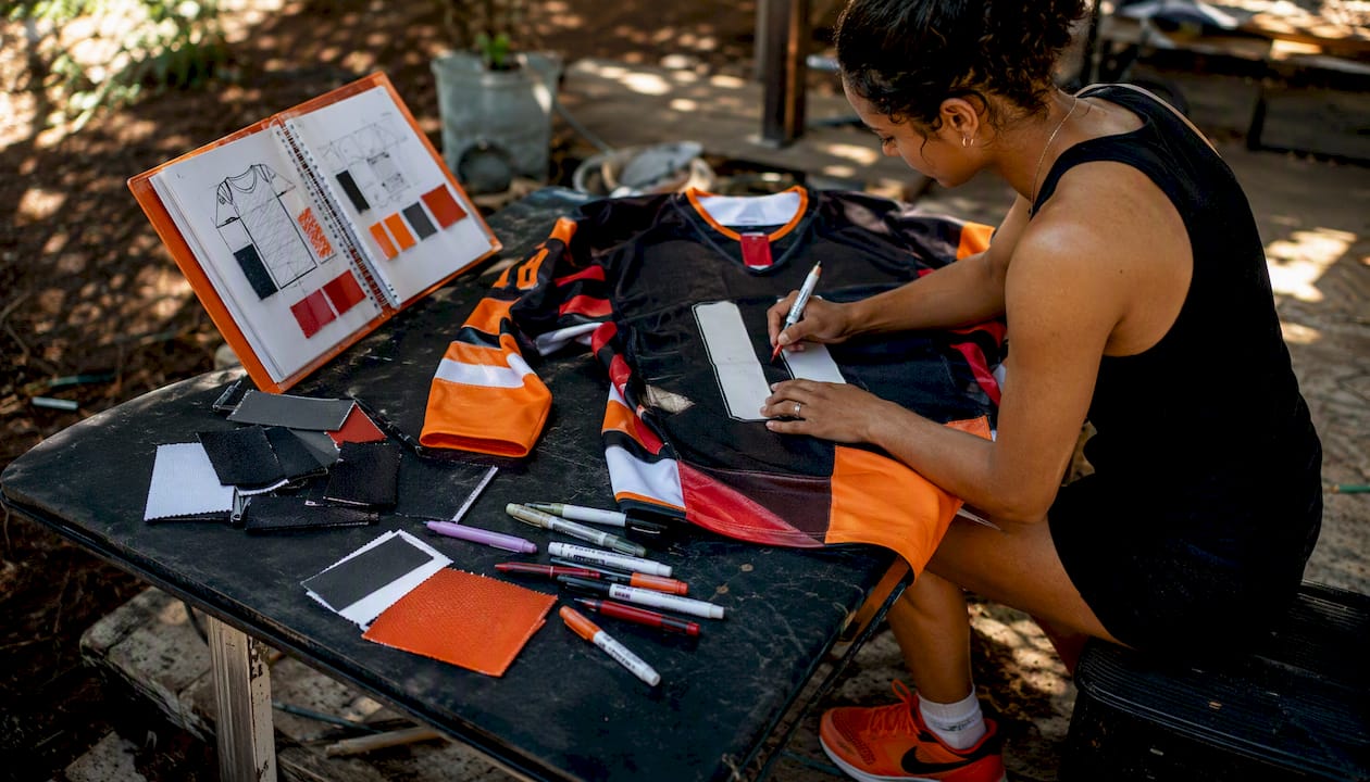 Hands sketching hockey jersey design concepts