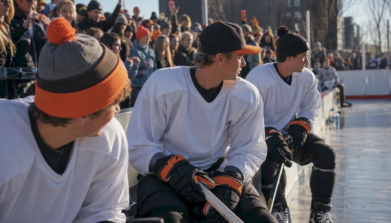 Hockey players and fans wearing team spirit hats