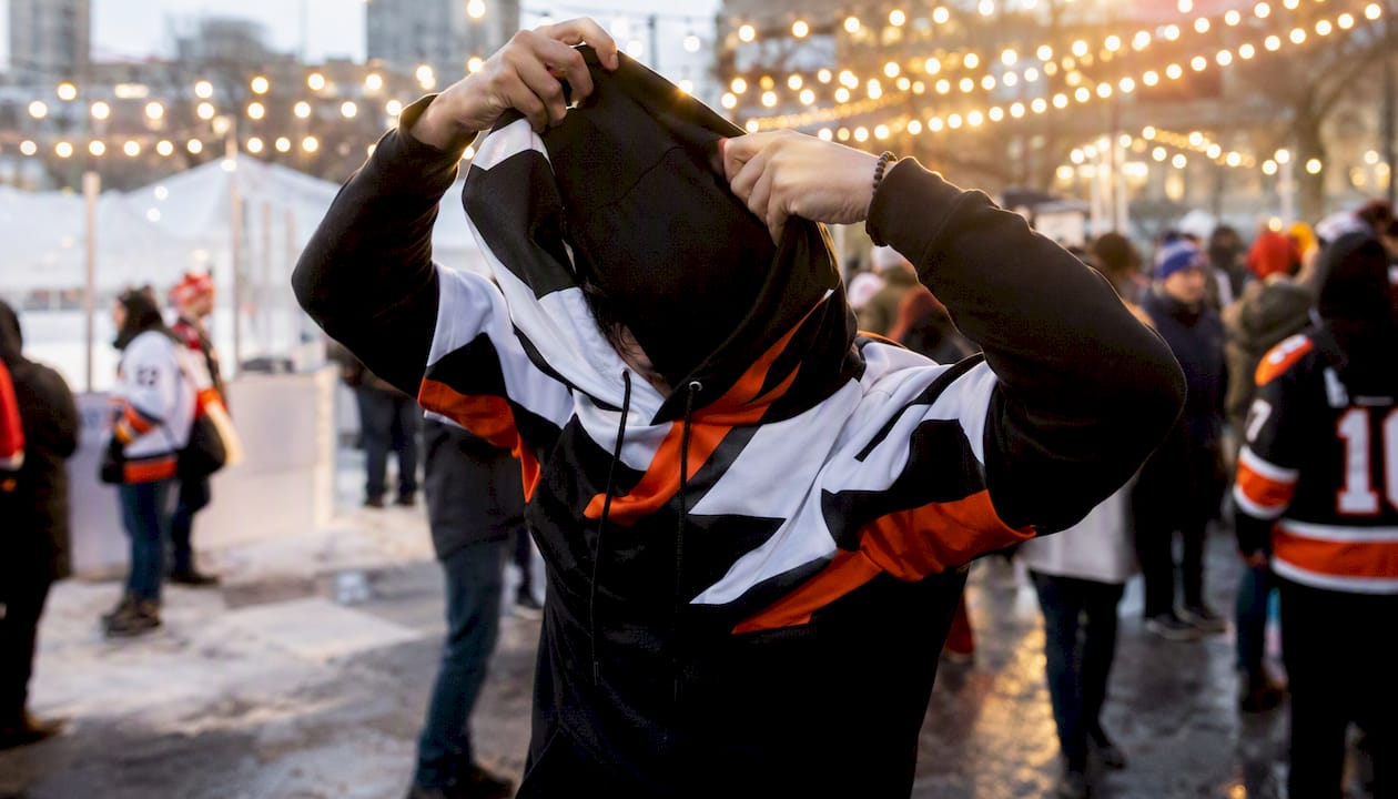 Fan pulling on distinctive hockey hoodie