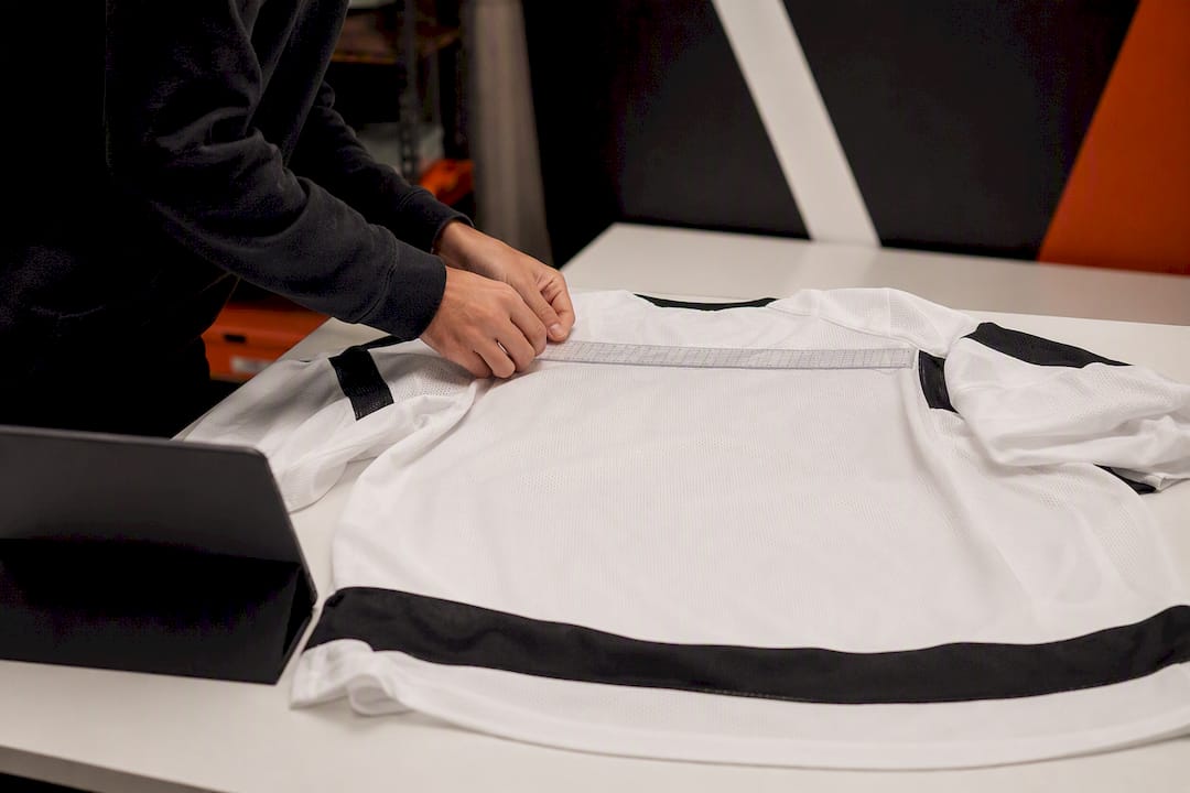 Hands positioning design on hockey jersey in studio