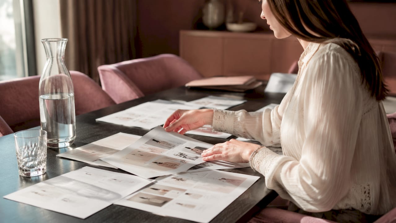 Hands examining skincare certification papers