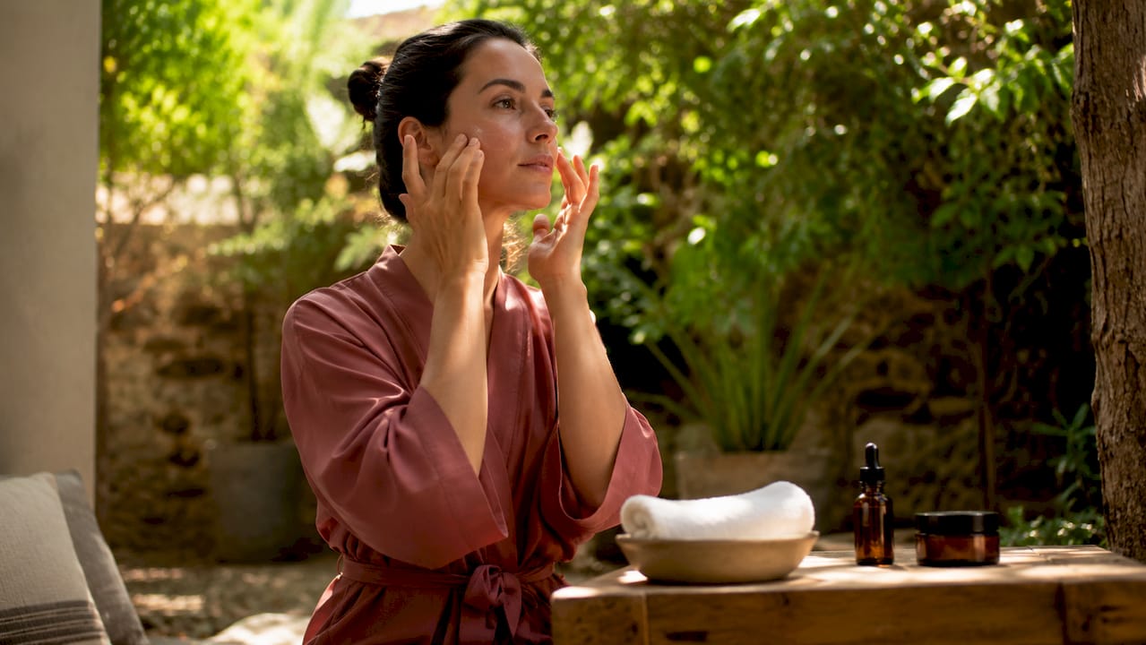 Professional applying skincare serum in clinical setting