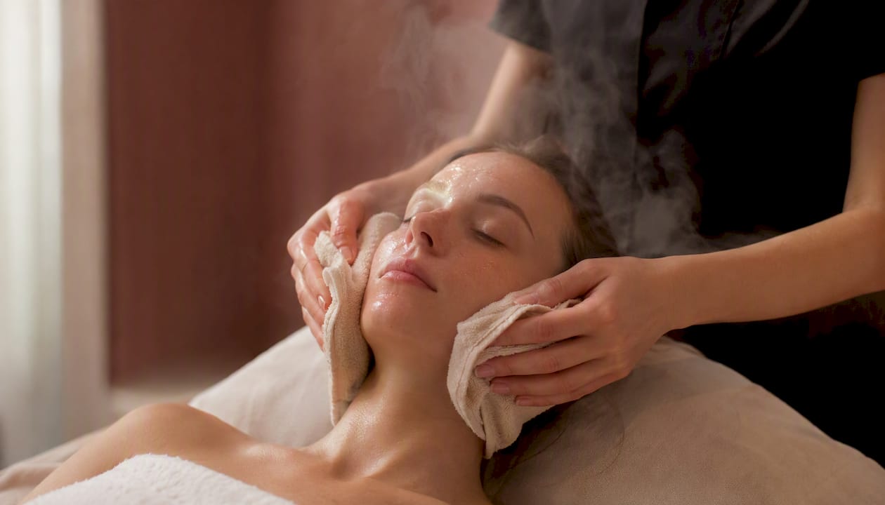 Warm towel applied to face to activate enzyme peel