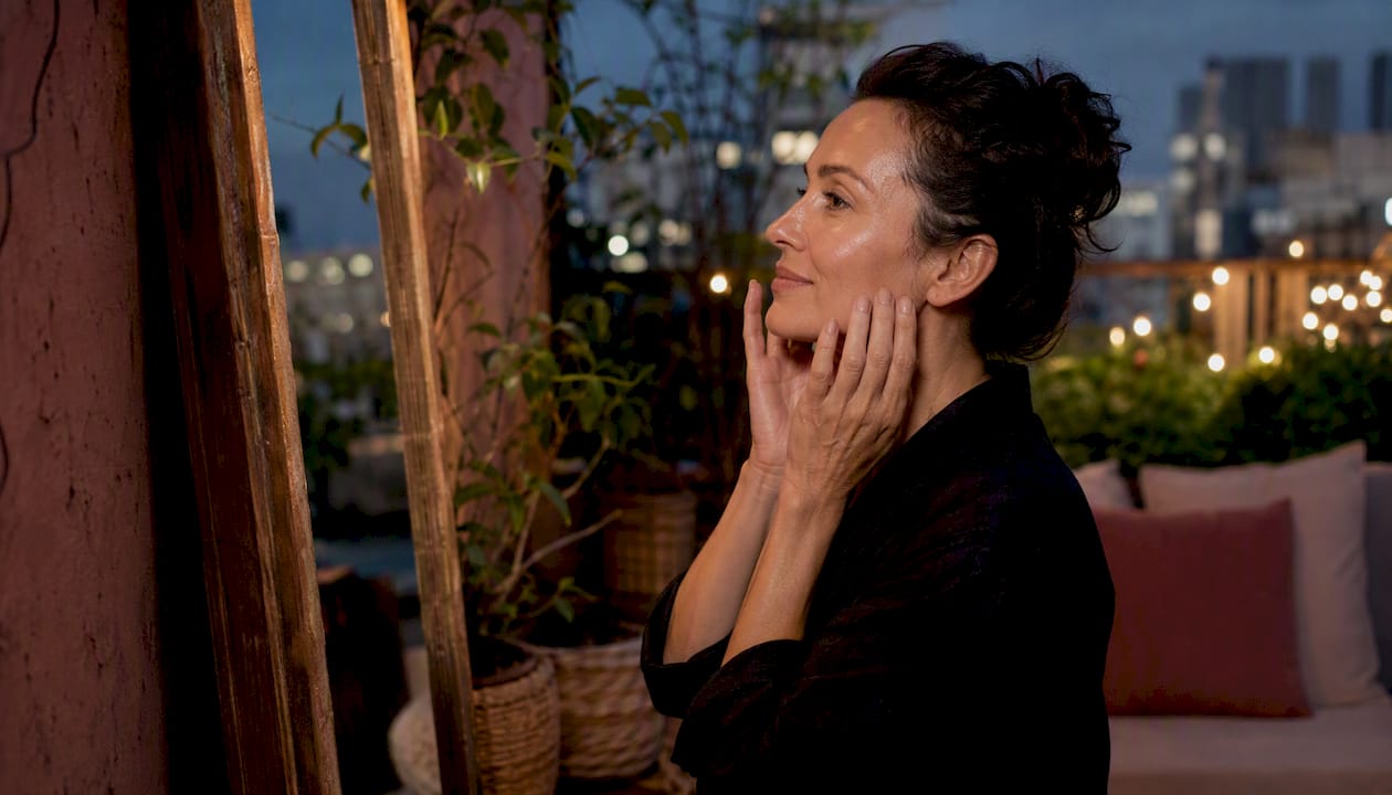 Woman applying moisturizer post-treatment