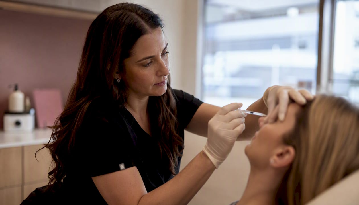 Clinician injecting Botox into forehead