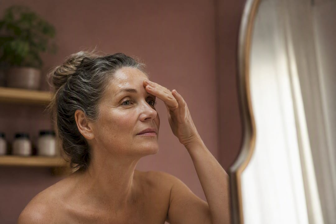 Woman applying skin serum in calm room